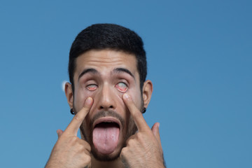 portrait of young man making faces