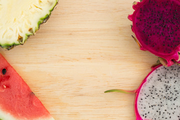 Slices of watermelon ,pineapple and Red & White Dragon fruit on wooden background,Space for text.
