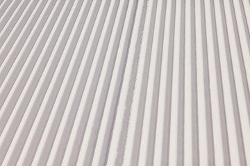 Obraz premium Texture of new groomed snow on empty ski slope