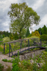 Beautiful metal forged bridge in a park. Bridge of Lovers