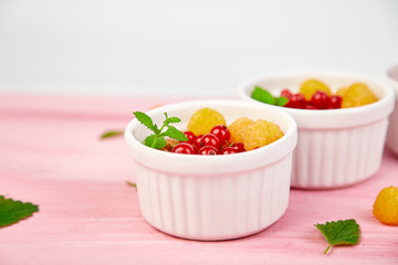 Healthy breakfast on white bowls. Fresh granola,