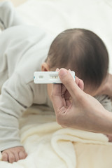 Pregnancy test with positive pregnant in  women hand with blurred baby background: Concept of family