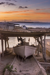 Fishing boat on its jetty at sunset
