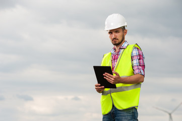 Fototapeta premium Seious young male engineer in white helmet
