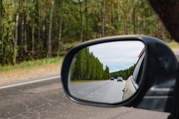Obraz premium look in the rear view mirror of a car