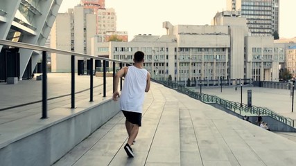 Running young man doing parkour tricks. Gimbal shot. Stabilized footage. - Powered by Adobe