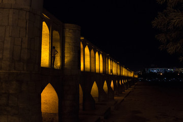 Si o Seh Pol bridge on a dark evening in Isfahan, Iran. Also known as Allahverdi Khan Bridge, or 33 arches bridge, it is a major landmark of the city and a symbol of the Persian Safavid Architecture
