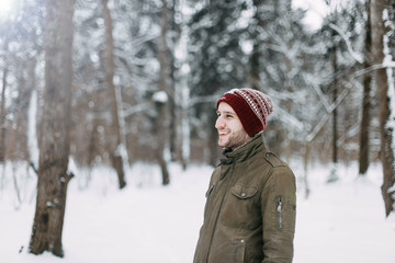 man, winter, background, portrait, white, young, beautiful, forest, hat, red, people, caucasian, face, snow, stylish, knitted, style, fashion, male, orange, outdoor, boy, seasonal, eyes, december, jan