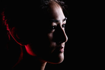 Portrait of woman in dramatic light.