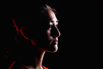 Portrait of woman in dramatic light.