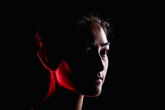 Portrait Of Woman In Dramatic Light.