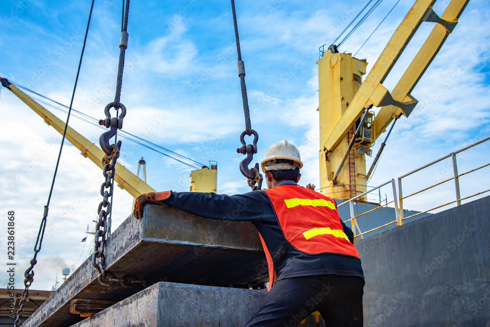 Wall mural bundle of steel slab being loading discharging in port terminal, handle by gang of stevedore labor ,