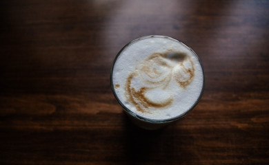 fragrant cappuccino on a wooden table in a glass.
