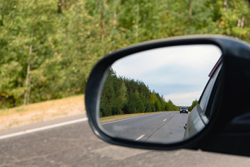 look in the rear view mirror of a car