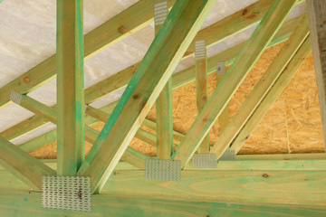 New residential construction home framing against a sunny sky.Local focus.