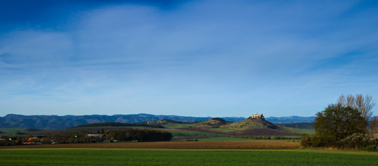 Northern panoramic view of Spis castle, Drevenik, Ostra hora and Slovak Ore Mountains in early spring with power lines removed from the picture