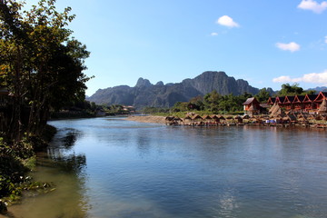 Fototapeta na wymiar Vang Vieng, Laos - January 1, 2016 : Travel Song River, The river clear and mountain view beautiful and blue sky