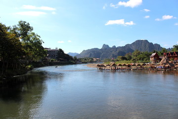Fototapeta na wymiar Vang Vieng, Laos - January 1, 2016 : Travel Song River, The river clear and mountain view beautiful and blue sky