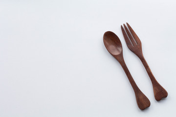 Wooden spoon and fork heart shaped with on a white background.