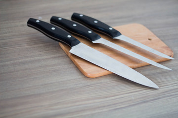 Collection Chef's knife and Chopping board on wood table.
