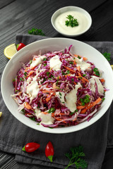 Coleslaw salad with red, white cabbage, carrot, parsley, sesame seeds. served with mayonnaise and lemon