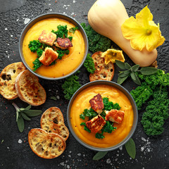 Baked butternut squash and carrot cream soup with steamed kale and fried halluomi