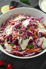 Coleslaw salad with red, white cabbage, carrot, parsley, sesame seeds. served with mayonnaise and lemon
