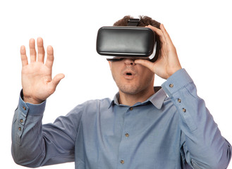 Man in Viara wearing glasses in shirt on white isolated background. Helmet virtual reality gadget concept. Man surprised gestures with his hands