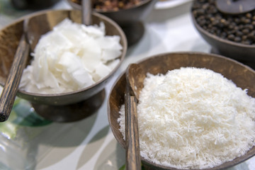 White coconut shavings in a wooden bowl.