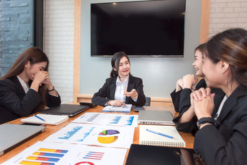 Group of businesswoman working in the office discussing documents and ideas at meeting