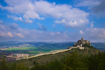 Fototapeta na wymiar A southern view of the Spis castle and Spisske podhradie in the morning in early spring with dramatic cloudy sky