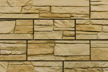 Modern yellow  brick wall. Pattern of decorative stone wall background. Surface brown wall texture