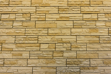 Modern yellow  brick wall. Pattern of decorative stone wall background. Surface brown wall texture