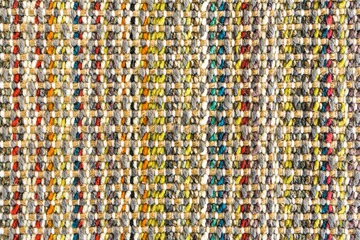 Multicolored knitted fabric background texture, colored carpet, bright wicker colorful rug