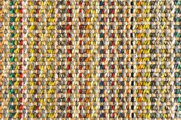Multicolored knitted fabric background texture, colored carpet, bright wicker colorful rug