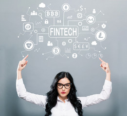 Cryptocurrency fintech theme with business woman pointing upwards on a gray background