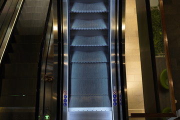 Illuminated escalator in a shopping mall