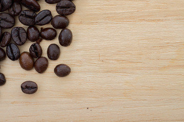 Coffee beans on wooden background. Coffee is a popular drink concept.