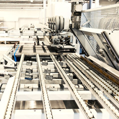 Piece of conveyor belt with rollers and supports.  Industrial background. Modern production...