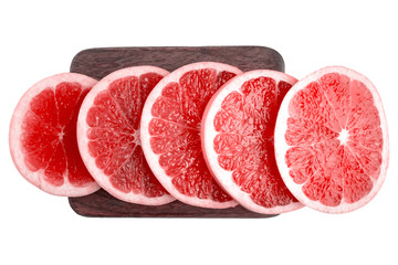 Pink and red grapefruit slices on wooden board. Isolated on white for your design. Top view.
