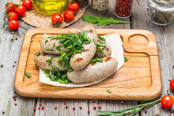 Sausages of chicken meat on a wooden table