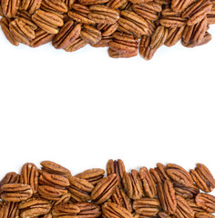 Pecan nut halves on white background with space for text. Top view, flat lay