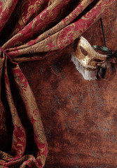 Old masquerade Venetian carnival mask with feathers and rhinestones.
