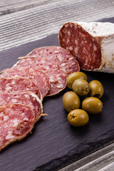Saucisson sec delicious french salami on a wooden background