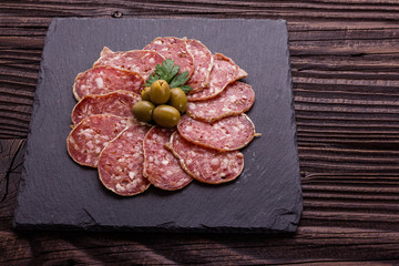 Saucisson sec delicious french salami on a wooden background