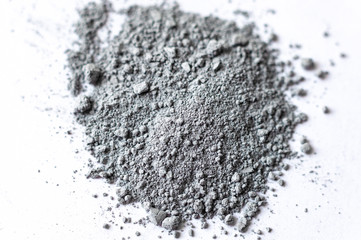 Fototapeta na wymiar Natural colored pigment powder close up, matt grey eyeshadow or powder mica pigment on a white background