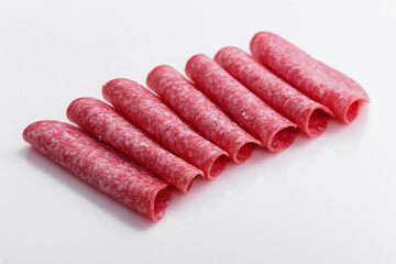 delicious sliced salami on a white background