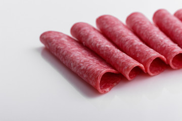 delicious sliced salami on a white background