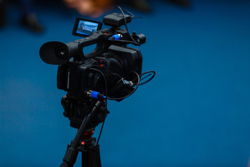 TV camera in a concert hall with laser lighting. Professional digital video camera.