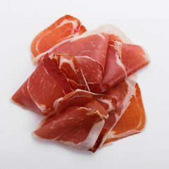Italian prosciutto crudo or spanish jamon on a white background
